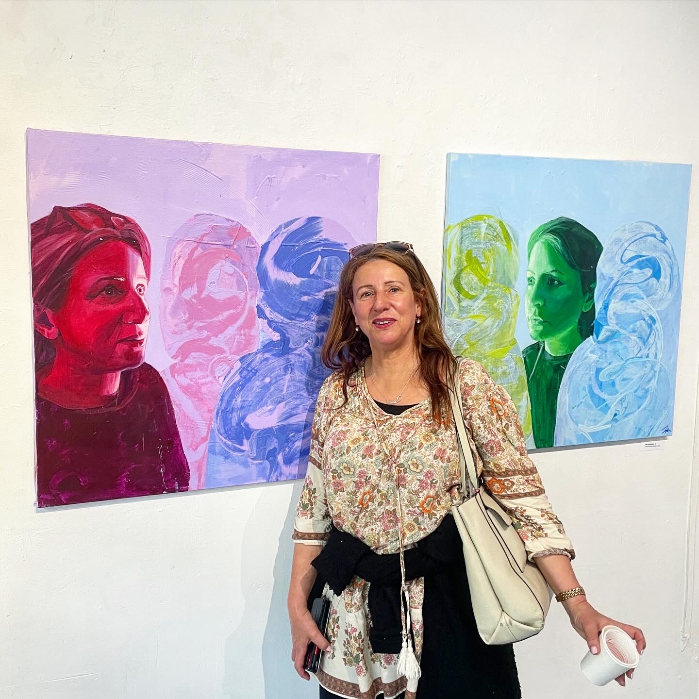 people watching painting on isabelle de brito and isabel backman cashmans exhibition posing in front of painting